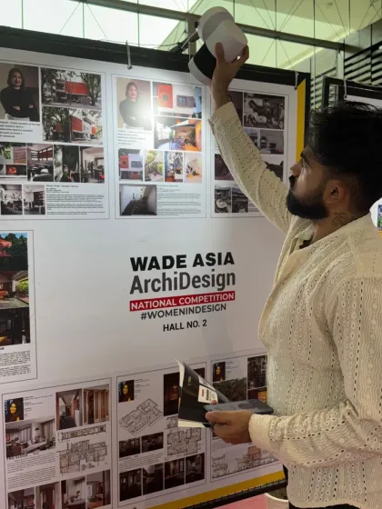 My partner, Sandesh, adjusting the lighting on our presentation board at the WADE Asia event.
