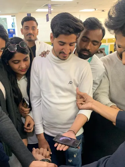 Using a guest's own phone for a modern magic trick. Incorporating personal items makes the illusion feel even more impossible and memorable for the spectator.