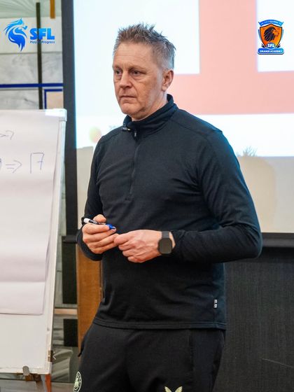 Heimir Hallgrímsson leading a technical workshop. We invest in our coaches' education to ensure they are equipped with the latest and most effective training methods.