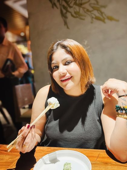 A personal shot of me enjoying sushi. This kind of content feels personal and trustworthy, like a recommendation from a friend, which is highly effective for restaurant promotions.