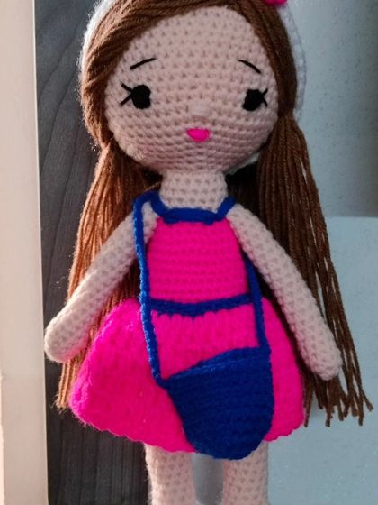 Another angle of the doll in the pink and blue outfit, showing her long brown hair.