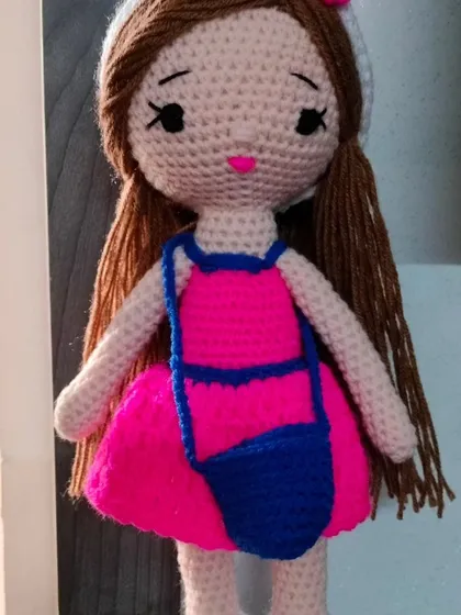 Another angle of the doll in the pink and blue outfit, showing her long brown hair.