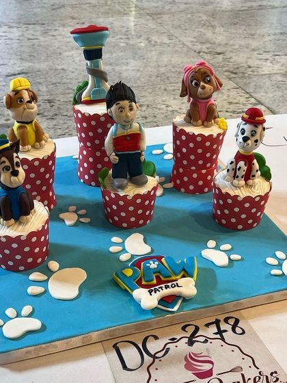 Our full Paw Patrol cupcake display, featuring all the main characters. The bright blue fondant base with paw prints completes the theme, making it a perfect centerpiece for a kid's birthday party.