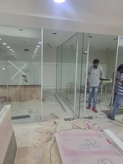 A before-and-after glimpse of our office renovation. This image shows the raw space during the installation of the glass partitions, highlighting the transformation into the bright, open, and polished Furbishy HQ.