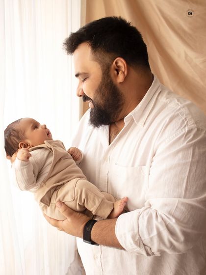 A father's gentle gaze at his newborn baby. These quiet, candid moments between a dad and his new child are some of my favorite to capture.