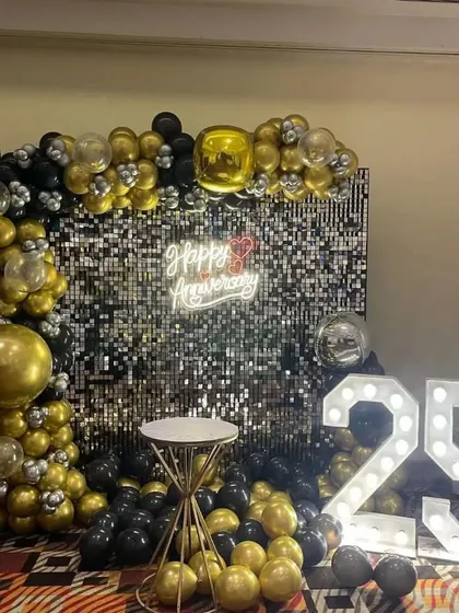 A full view of the black and gold 25th-anniversary backdrop, perfect for a grand celebration.