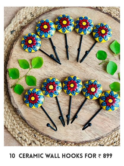 Our new mini ceramic wall hooks are here. This image shows a set of 10 in a beautiful red and yellow floral design, perfect for hanging your macrame pieces, bags, or keys.