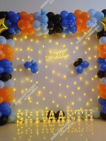 A square balloon arch with a light-up wall and marquee letters.
