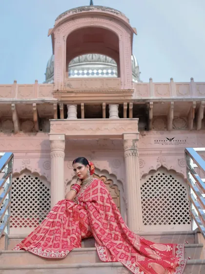 A low-angle shot of the model seated on the steps of the building, creating a majestic feel.