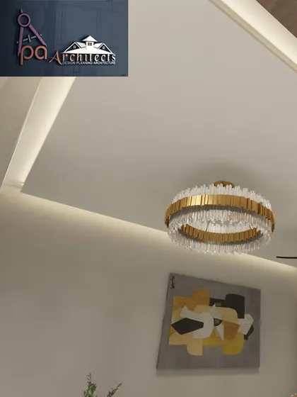 Lighting is a key element in our designs. Here, a modern crystal chandelier becomes the centerpiece of the room, complemented by recessed ceiling lights that provide soft, ambient illumination.