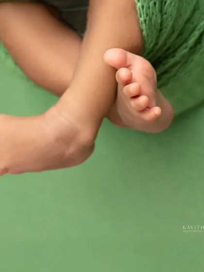 A black and white macro shot of a newborn's tiny feet. The focus on these details creates a powerful reminder of how small they once were.