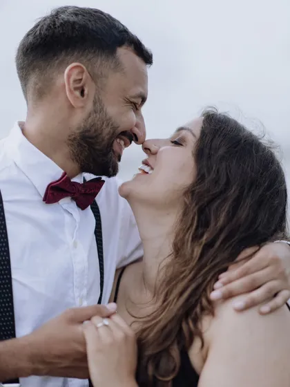 A happy and natural close-up of the couple, nose-to-nose and sharing a laugh. This candid shot is full of genuine joy and affection.