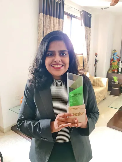 Holding my HerRising 2021 Women Starter award. This recognition was an important early milestone that celebrated my entrepreneurial spirit in launching a niche law practice.