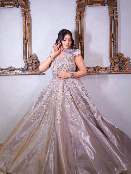 A full-length shot showing the gown's beautiful sheen and unique shoulder design.