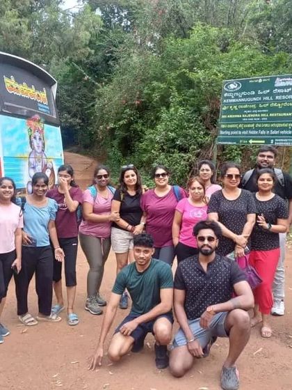 Our group posing in front of our tour bus at Kemmangundi, ready for a day of exploration.