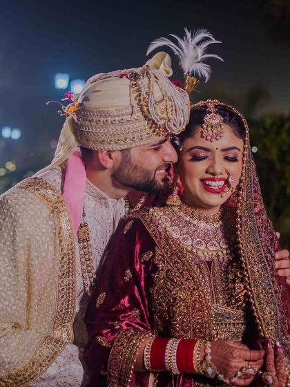 The bride and groom sharing a happy, candid moment. Their smiles are so full of love.
