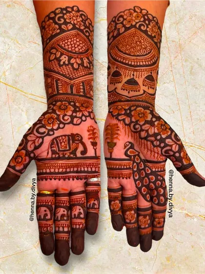 This royal bridal mehendi showcases a beautiful elephant procession on one palm and a peacock in a garden on the other. The arms feature palace domes and intricate floral work.