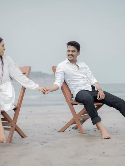 A relaxed and candid moment between a couple sitting on the beach. These simple, natural poses often result in the most authentic and cherished pre-wedding photographs.