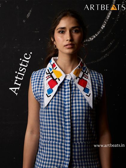 The Call of the Pharaohs dress, featuring an artistic collar with geometric, hand-detailed art. This piece is a conversation starter, designed to stand out.