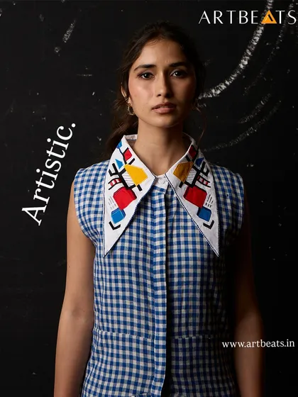 The Call of the Pharaohs dress, featuring an artistic collar with geometric, hand-detailed art. This piece is a conversation starter, designed to stand out.