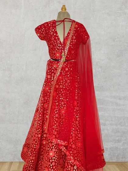 For those grand family weddings, I create outfits that are pure elegance. This stunning red lehenga choli features intricate embroidery and a timeless design, handcrafted to make your little girl feel like the star of the show.