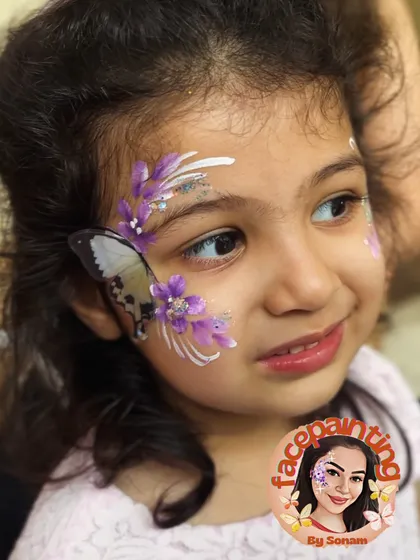 A sweet smile and a delicate purple butterfly. This simple design is perfect for younger children or those who want something subtle.