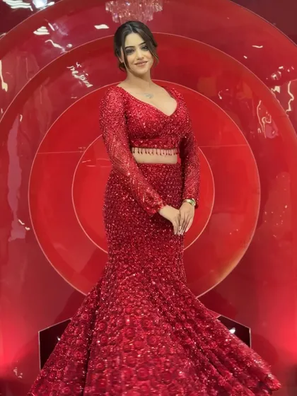 This all-red sequin fish-cut gown is a complete showstopper and one of our most requested pieces. It’s designed to hug your curves and make a statement at any reception or cocktail party. The intricate sequin work catches the light beautifully, ensuring all eyes are on you.