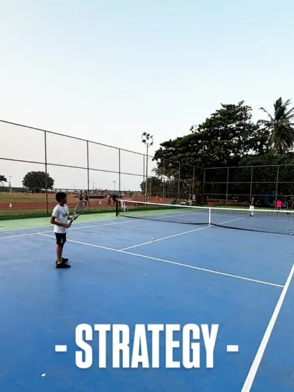 Tennis is as much a mental game as it is physical. This image captures a moment of strategy, as a young player assesses the court before making his next move during a practice match.