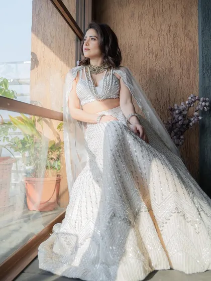 I styled Nushrratt Bharuccha in this ethereal ivory lehenga by Disha Patil for a wedding. The layered pearl necklaces add a touch of modern royalty, making it a standout look for a wedding guest.