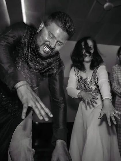 A candid black and white shot from the after-party. Pure, unchoreographed fun.