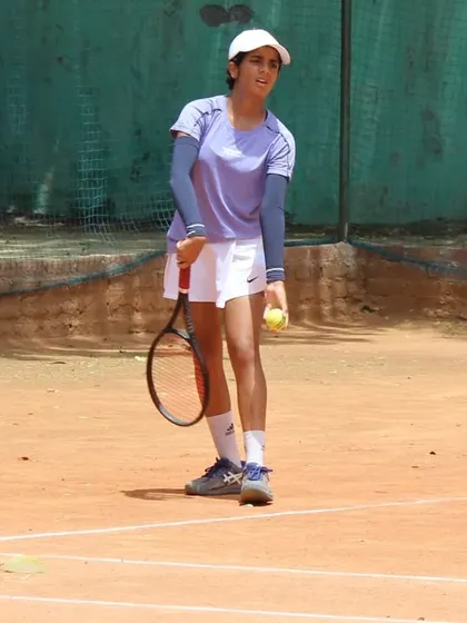 A player focused and ready to serve during a semifinal match. The serve is the most important shot, and we dedicate significant time to it.