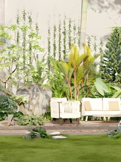 This backyard design focuses on creating a comfortable outdoor living room. A paved patio area is surrounded by dense, layered planting, providing privacy and a deep connection to nature.