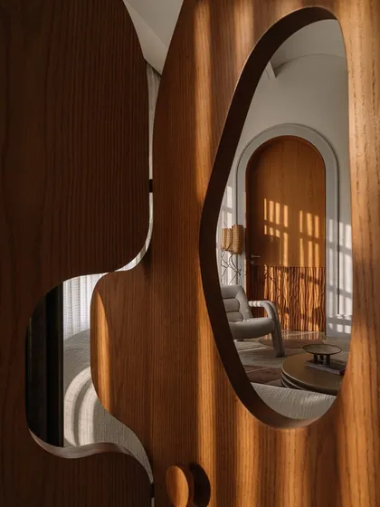 Our 'Hide N Seek' screen is furniture that invites play. Designed to divide a large suite into a salon and bedroom, its amoebic wooden panels have organic cutouts that frame views and create intriguing vignettes. It’s a sculptural piece that is both a space divider and an interactive art form.