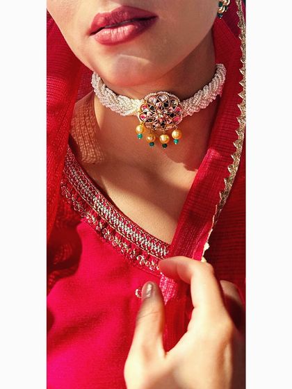 A close-up of a delicate, handcrafted kundan and pearl choker. This type of piece is perfect for a Mehendi or Sangeet, adding a touch of royalty without being overpowering.