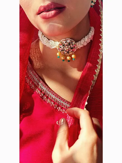 A close-up of a delicate, handcrafted kundan and pearl choker. This type of piece is perfect for a Mehendi or Sangeet, adding a touch of royalty without being overpowering.