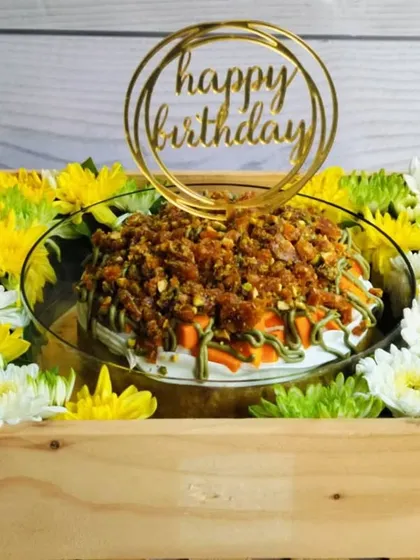 The vibrant colors of the Mango Pistachio Tres Leches hamper, with its yellow and green flowers, perfectly match the tropical flavors of the cake.