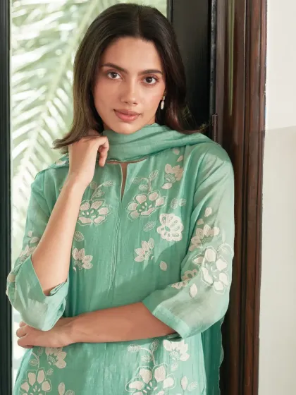 When the day calls for comfort, but you still want to look like you tried. This mint green suit with white floral embroidery feels just right for a casual festive gathering.