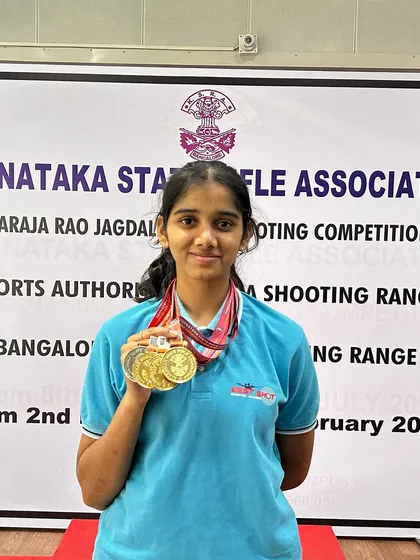 Anushka showcasing her impressive haul of three gold medals from the 1st Nagaraja Jagdale Shooting Competition in the Air Rifle event.