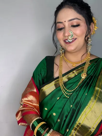A candid, smiling shot that captures the bride's happiness. The makeup is designed to look beautiful from every angle.