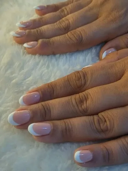 Another angle of the classic French manicure, highlighting the precision and finesse of the white tips.