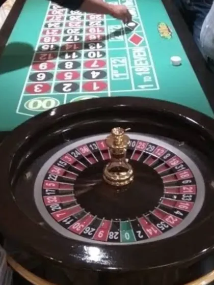 Bring the excitement of Las Vegas to your party with our casino game rentals. This professional roulette table setup, complete with chips, is perfect for a 40th birthday bash, corporate event, or a themed casino night.