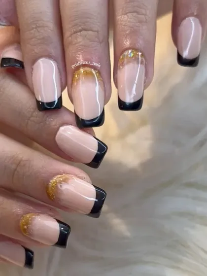Clean black French tips with an inbuilt glitter accent nail. This is a sophisticated look done on long, square acrylic extensions.