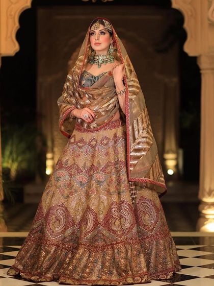 A full-length shot of the royal bride, showcasing the grandeur of her outfit and our statement jewellery.