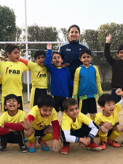 A team photo with their coach. We go beyond the game to foster skill development, exposure to challenges, and personal growth.