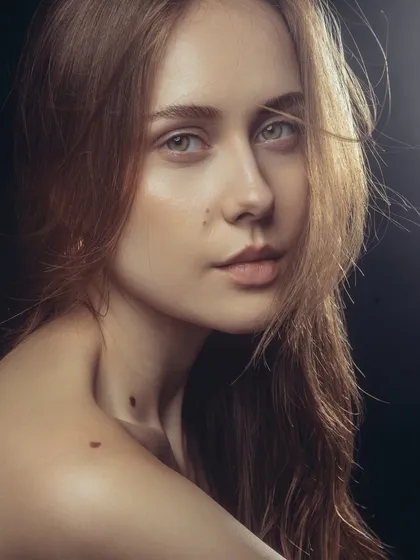 This portrait captures a raw and authentic beauty. The makeup is barely there, designed to even out the skin tone and add a slight glow, proving that sometimes the most effective makeup is the most subtle.