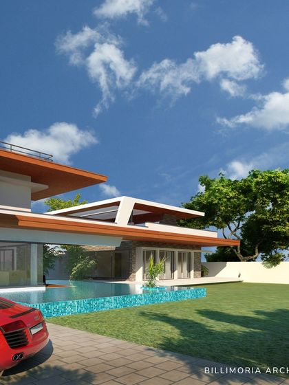 An alternate view showcasing how the home's L-shape design creates a private garden and pool area. The large sliding glass doors completely open up the ground floor to the outdoors.