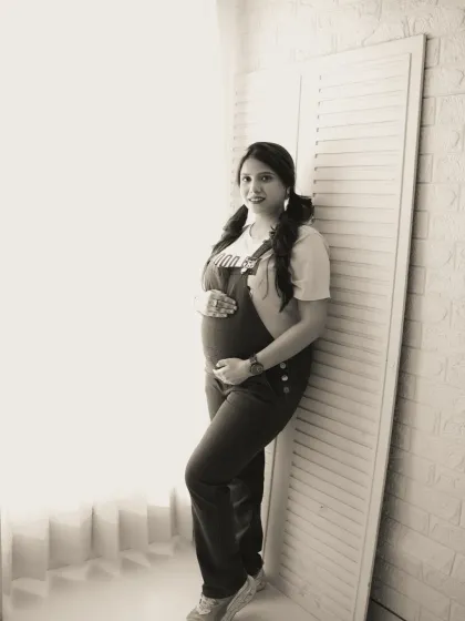 A cool and casual solo portrait in black and white. The mother-to-be's relaxed pose and fun pigtails give this shot a youthful and modern vibe.