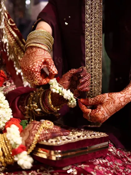 An aesthetic shot of a bridal henna stain, showing the intricate details of the design on the hands.