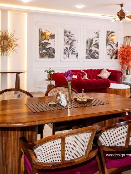 An overhead view of the dining area, emphasizing the beautiful grain of the solid wood table and the classic elegance of the cane-back chairs.