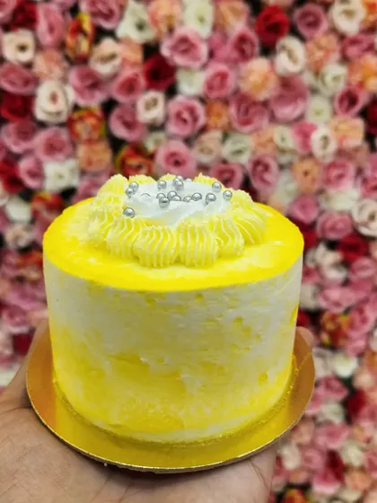 Bright, fresh, and tropical. My mini pineapple cake is a burst of sunshine, with a light sponge and sweet pineapple flavor. Topped with a swirl of yellow frosting and silver sprinkles, it's a delightful personal-sized dessert.